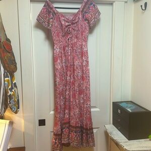 Vibrant boho maxi dress with shirred top and adjustable front tie.